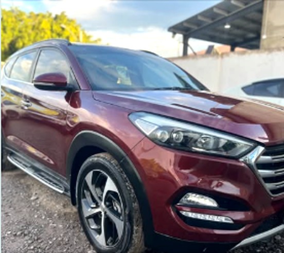 Burgundy Hyundai Tucson from a front side angle